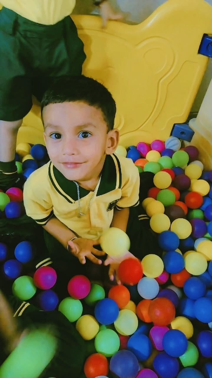Student playing in the ball pit